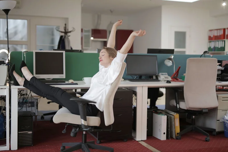 Man stretching back in his office chair