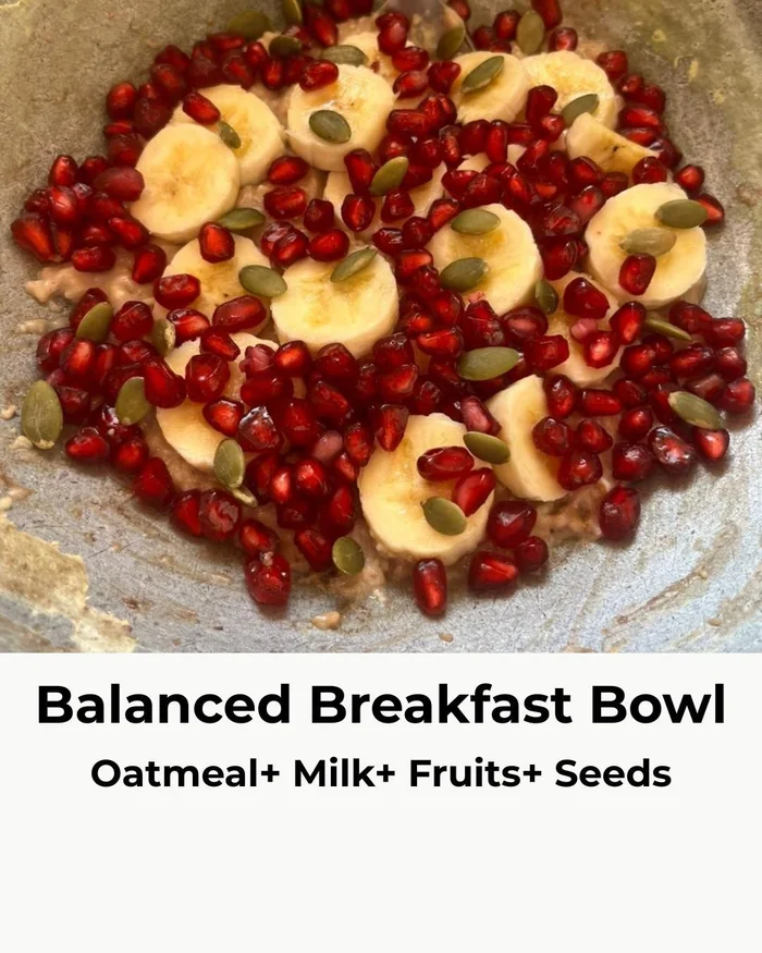 Balanced breakfast bowl of oatmeal, milk, fruit and seeds