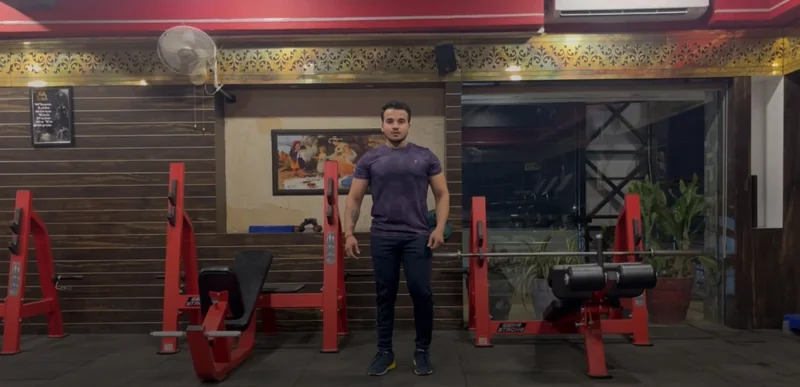 Trainer demonstrating a bodyweight workout on camera