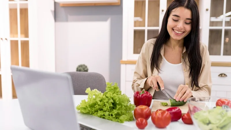Woman preparing a fresh meal from her online nutrition plan
