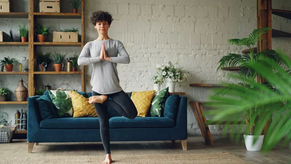 Instructor demonstrating a held hatha yoga posture