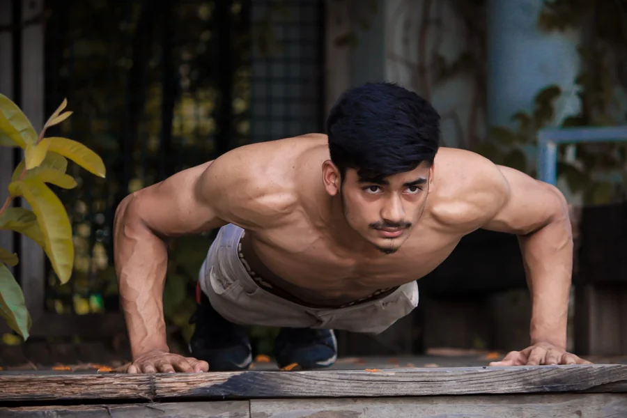 Man doing push-ups as part of a home fitness challenge