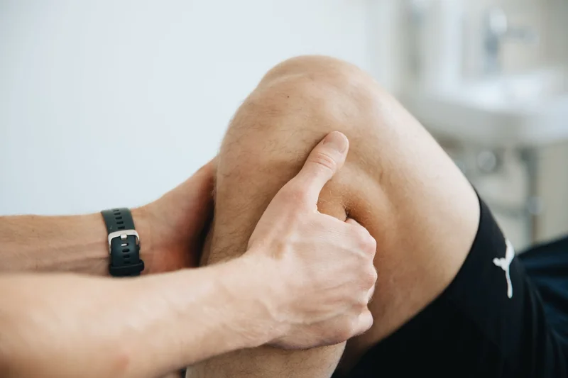 Hands supporting a knee during a controlled movement
