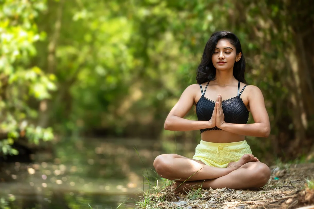 Woman meditating with her palms together
