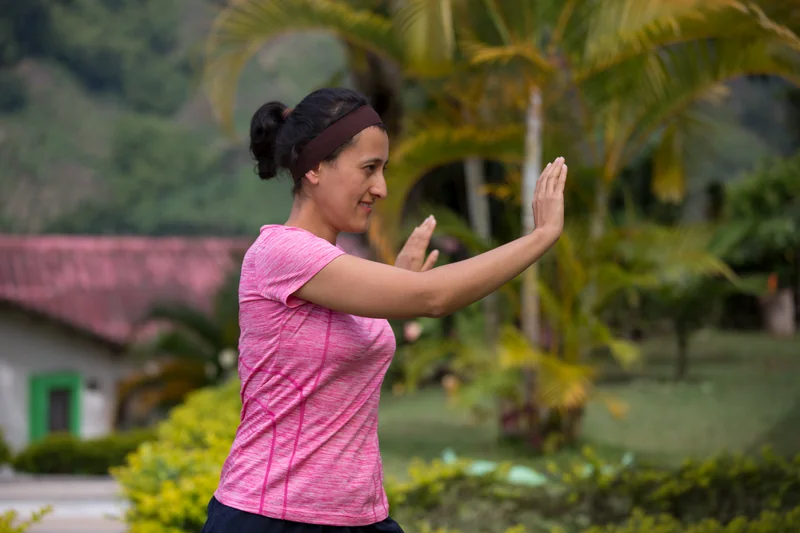 Woman doing an energetic dance workout outdoors