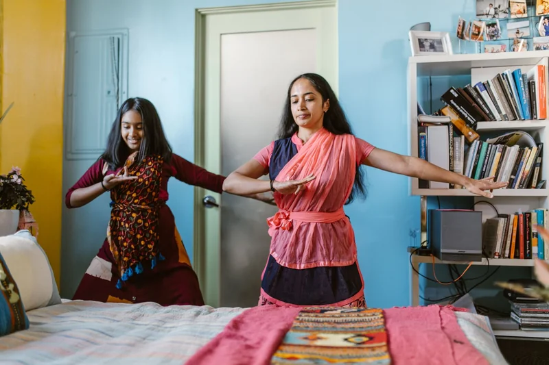 Two women dancing in their living room